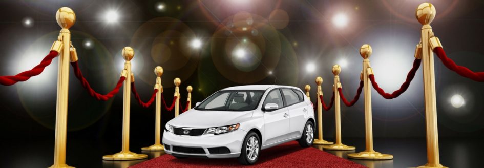 A used Kia Forte on a red carpet