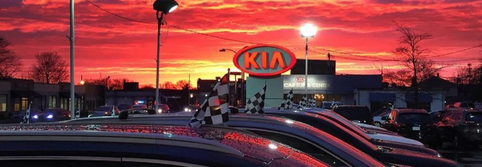 A Kia sign against a sunset featured in a blog post about a Kia dealer